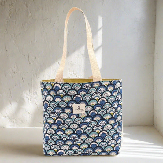 blue and green fabric bag with waves and a cotton handle